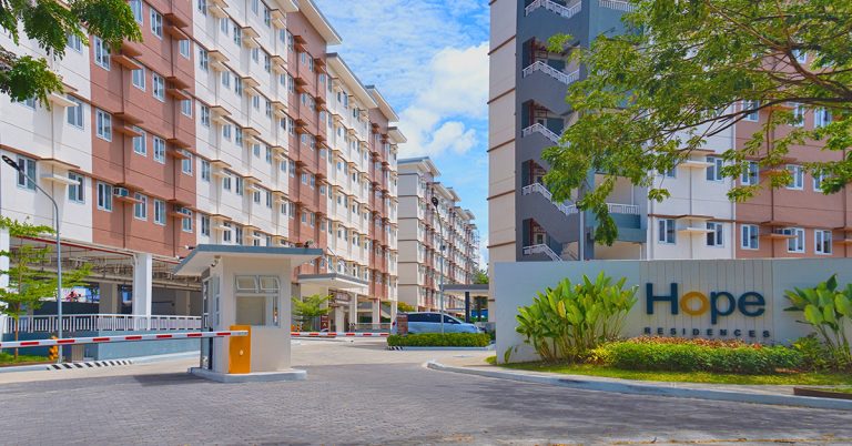 Outdoor amenities with a swimming pool and playground area in front of a building, offering recreational opportunities.