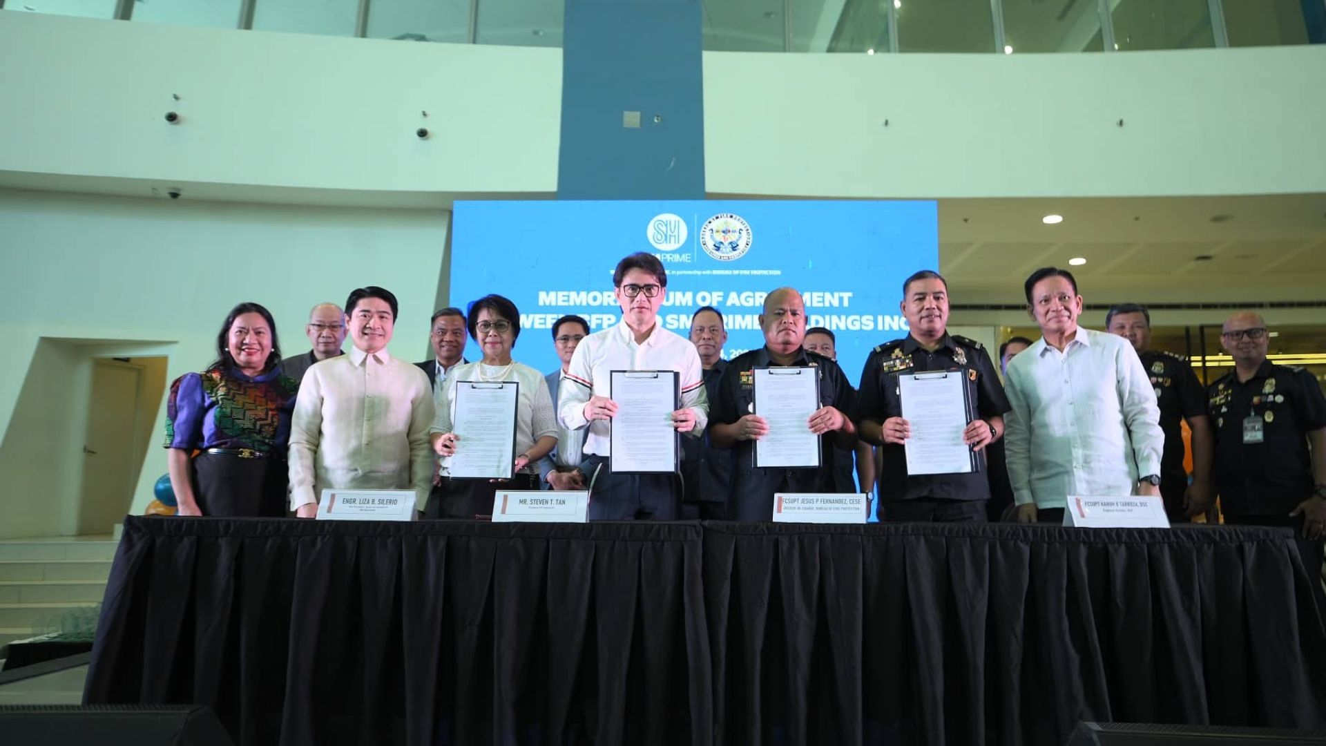 SM Leaders and Bureau of Fire Protection Officials sign the memorandum of agreement, signifying the renewed commitment to fire safety and prevention campaigns. 