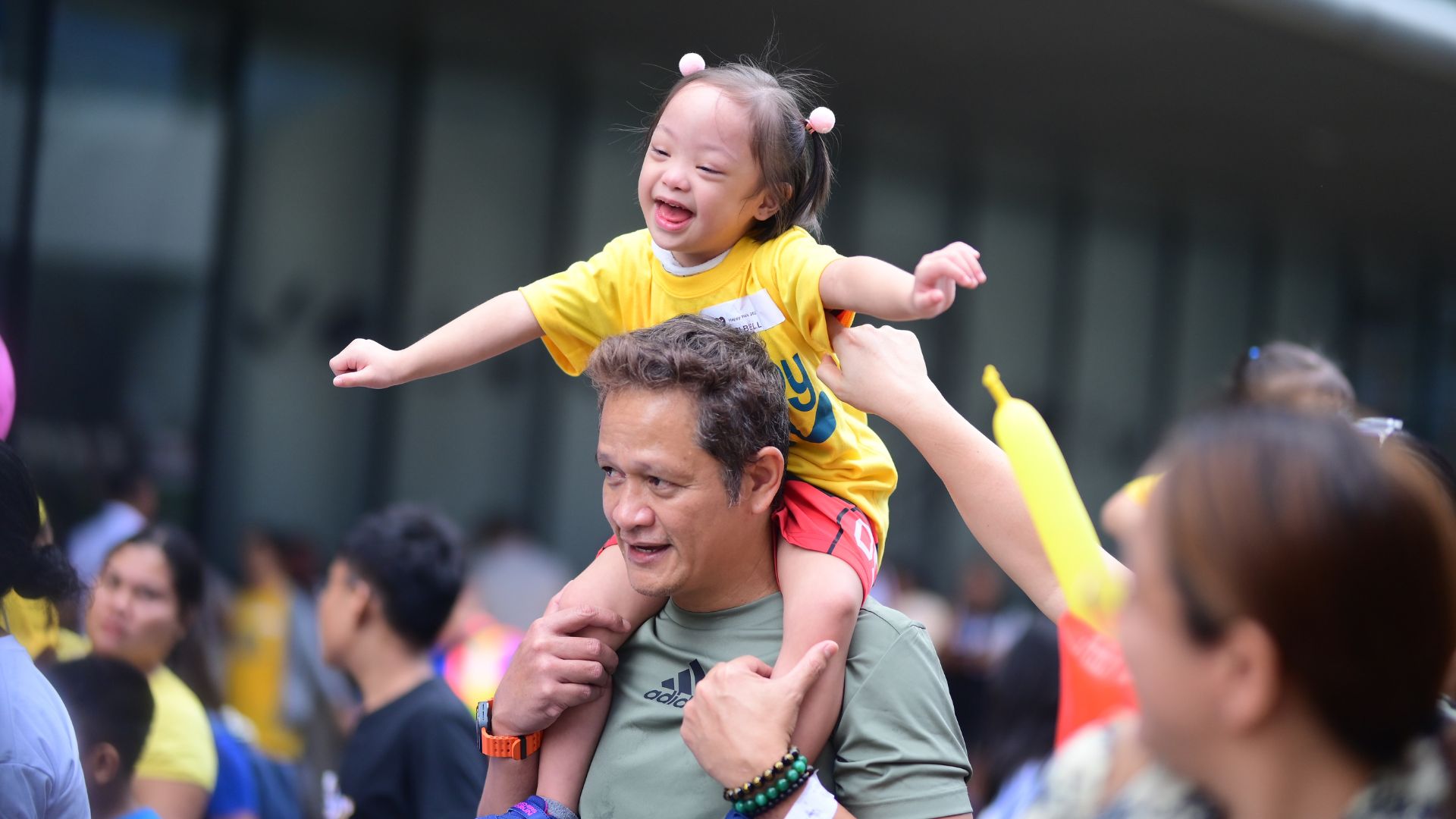 A father and child happily join the parade, giving us a touching moment and another reason to strengthen our commitment to inclusivity.