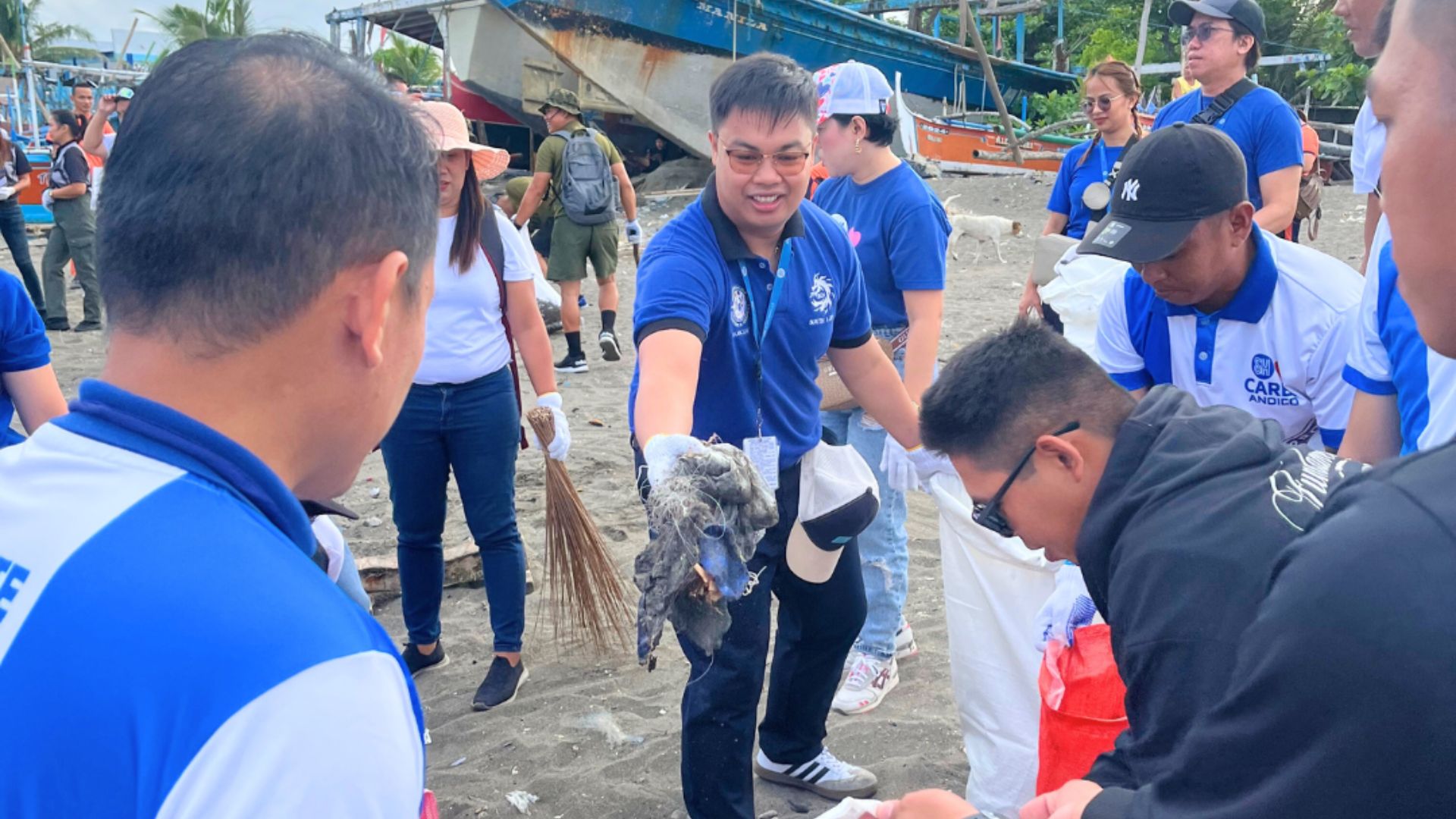 SM City Tanza volunteers join a Philippine Coast Guard coastal cleanup, demonstrating SM Prime's environmental commitment.